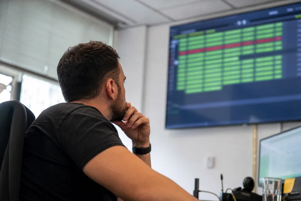 Engineer watching a wall display of blacklist status rows with one listed entry