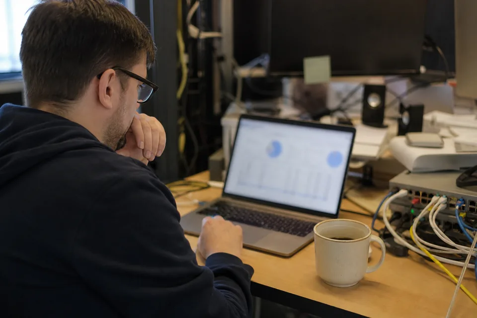 IT administrator reviewing a DMARC authentication report on a laptop